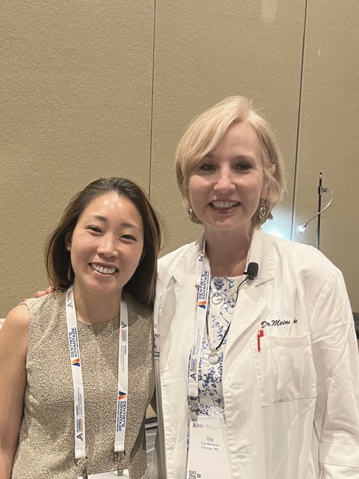 Dr. Erin Cho at a dental conference, wearing an award recipient badge