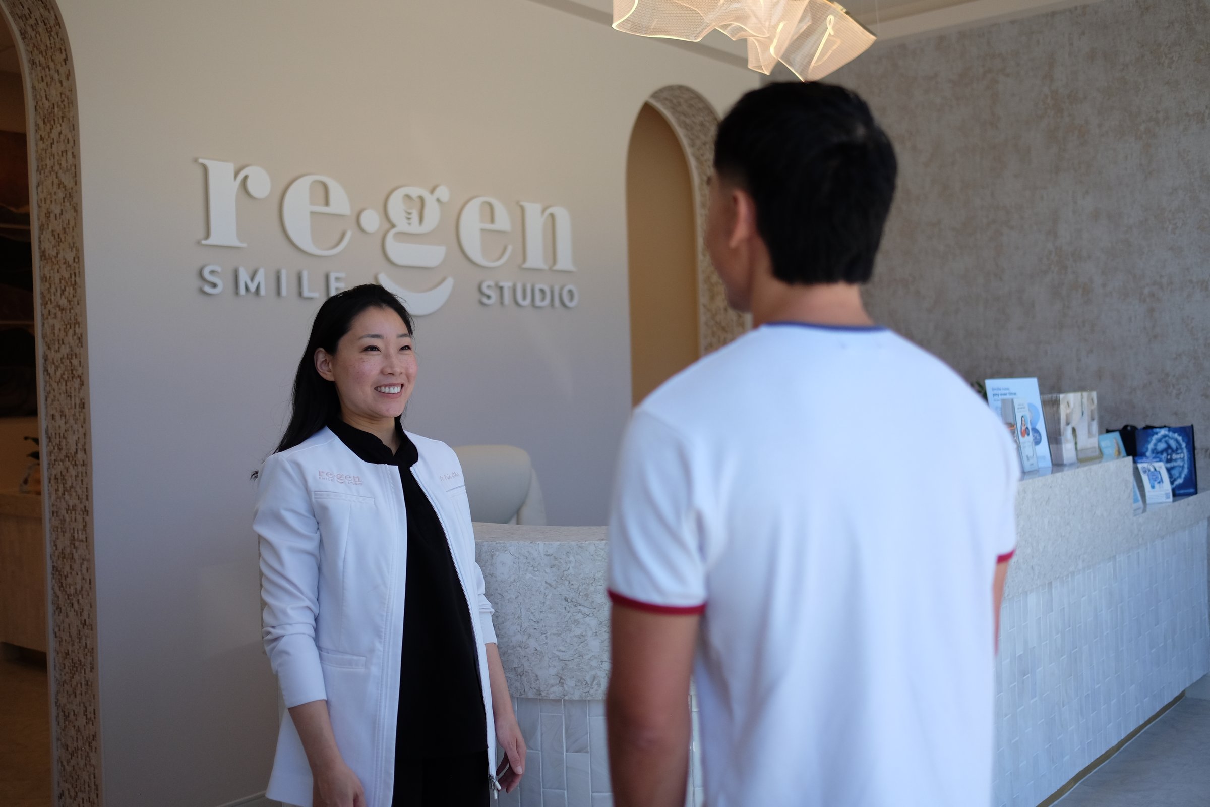 Dr. Erin Cho greeting a patient at reception