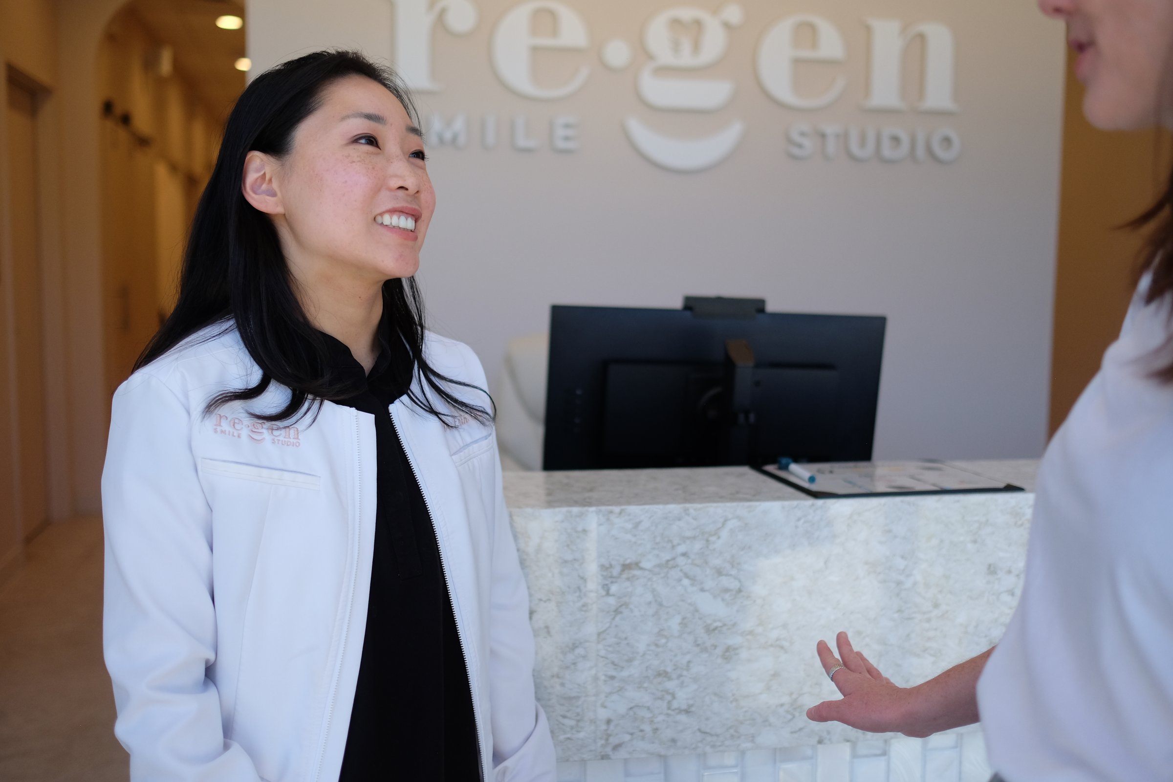 Dr. Erin Cho talking with a patient at reception
