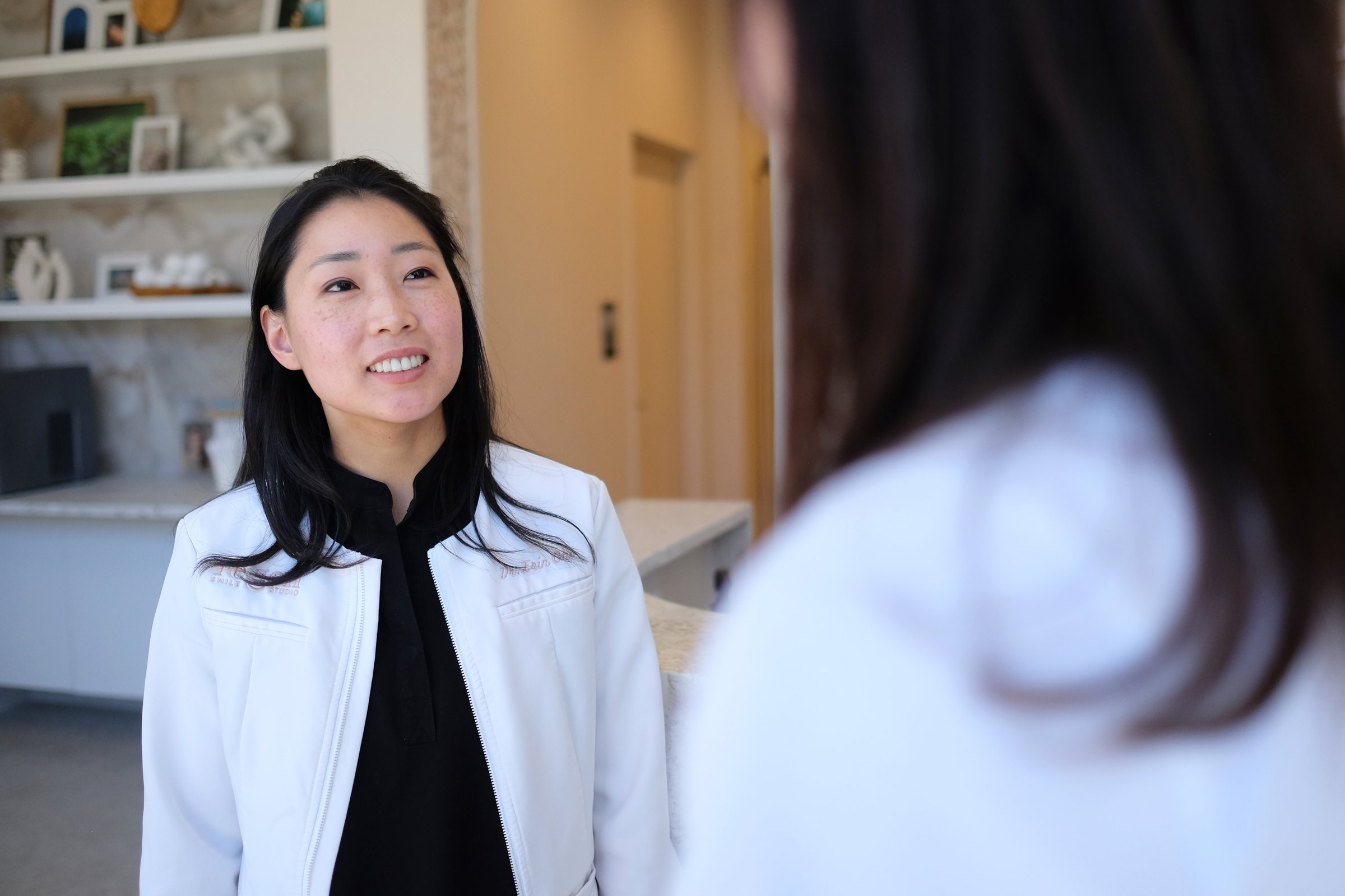 Dr. Erin Cho listening to a patient in the studio