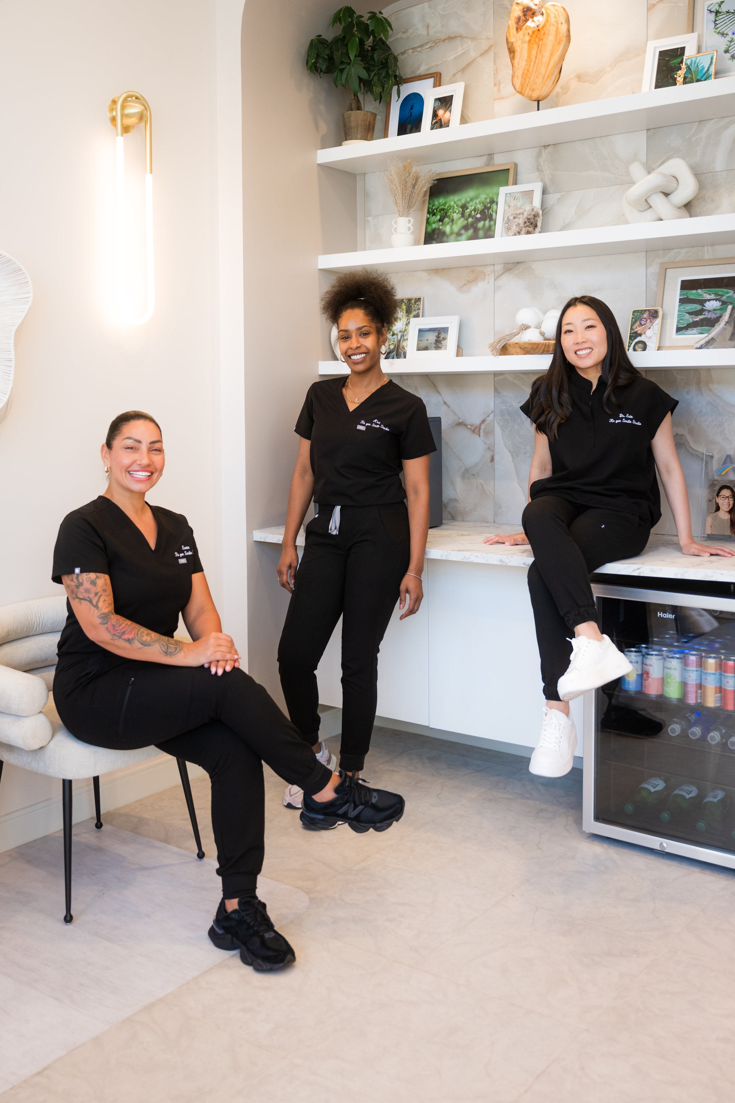 Members of the Re·gen team by the shelves in the studio