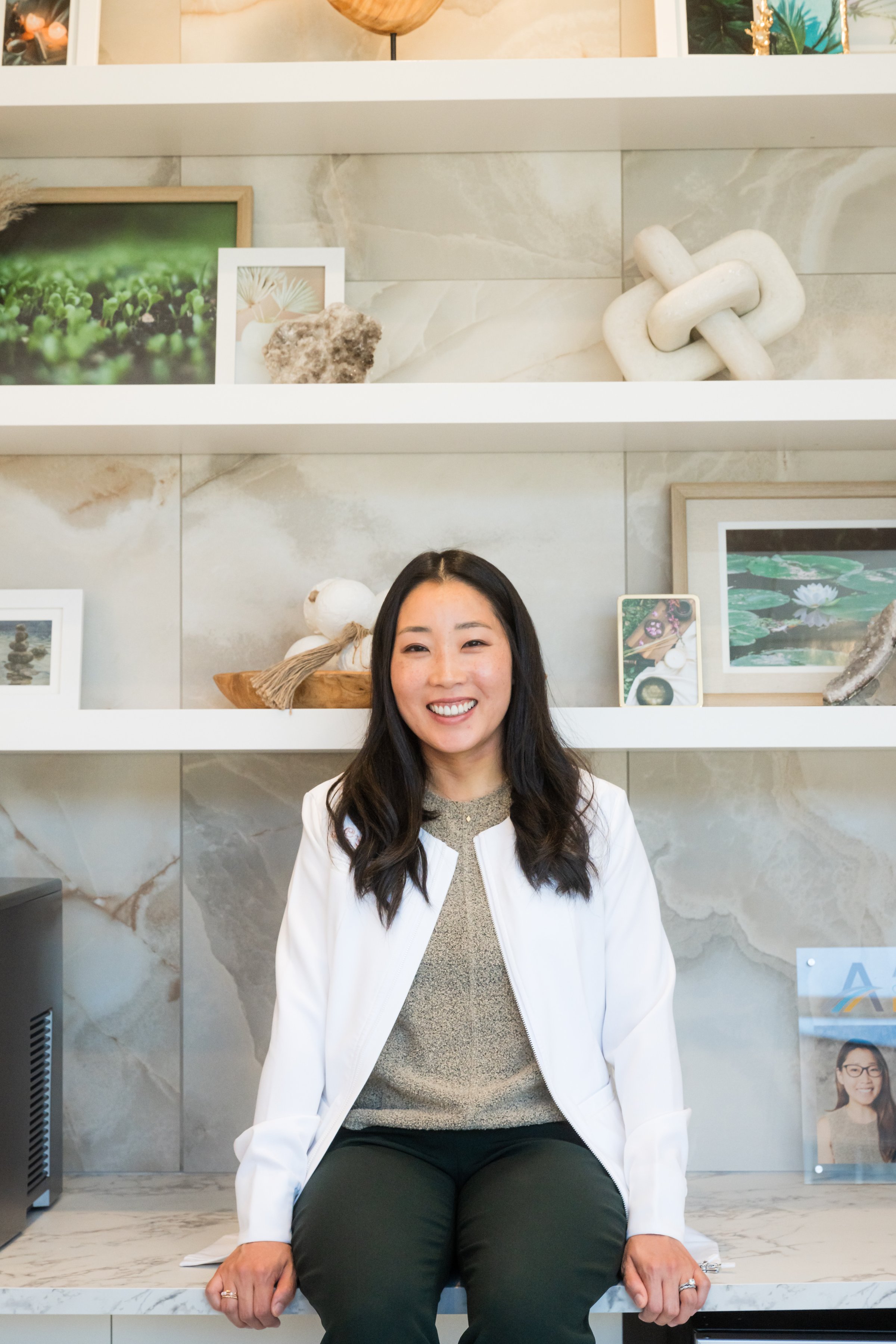 Portrait of Dr. Erin Cho in her white coat, seated in the studio