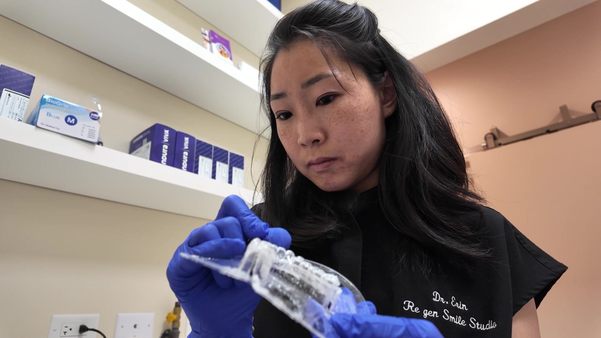 Dr. Erin Cho holding a clear tray