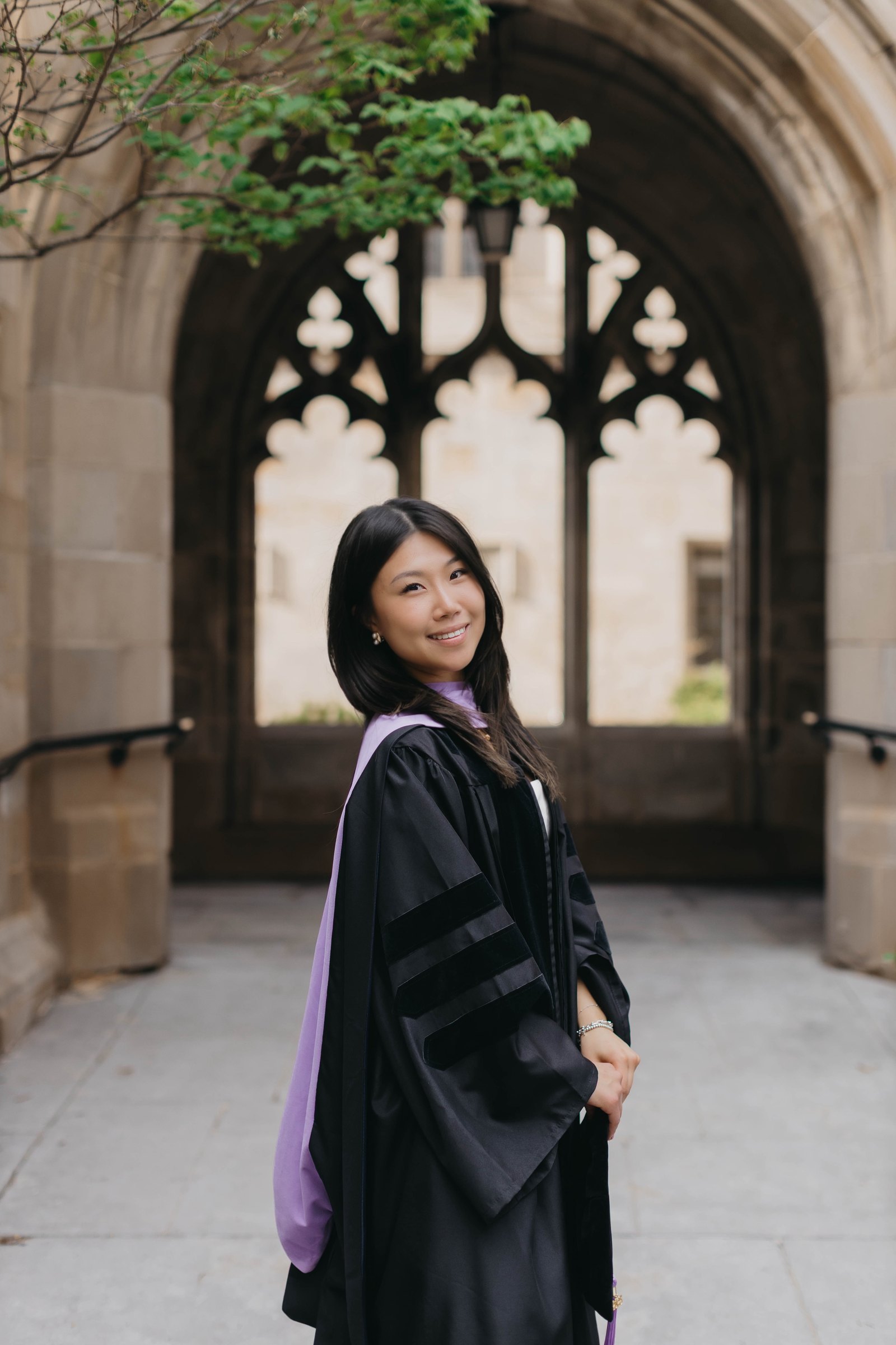 Dr. Ashley Choi in her doctoral gown on graduation day