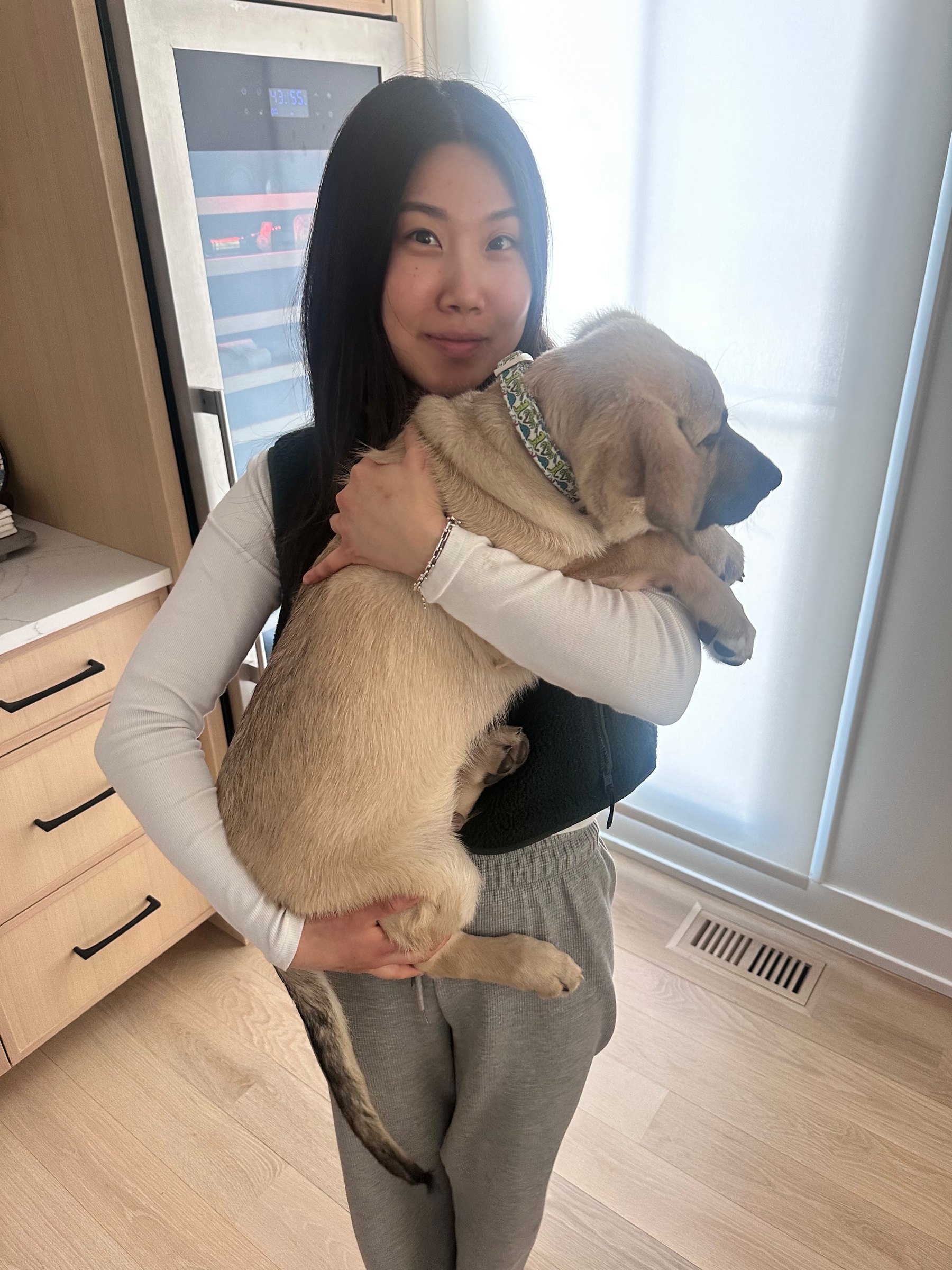 Dr. Ashley Choi holding her puppy, Theo